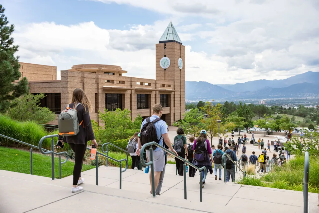 students walking on campus in front of El Pomar Center